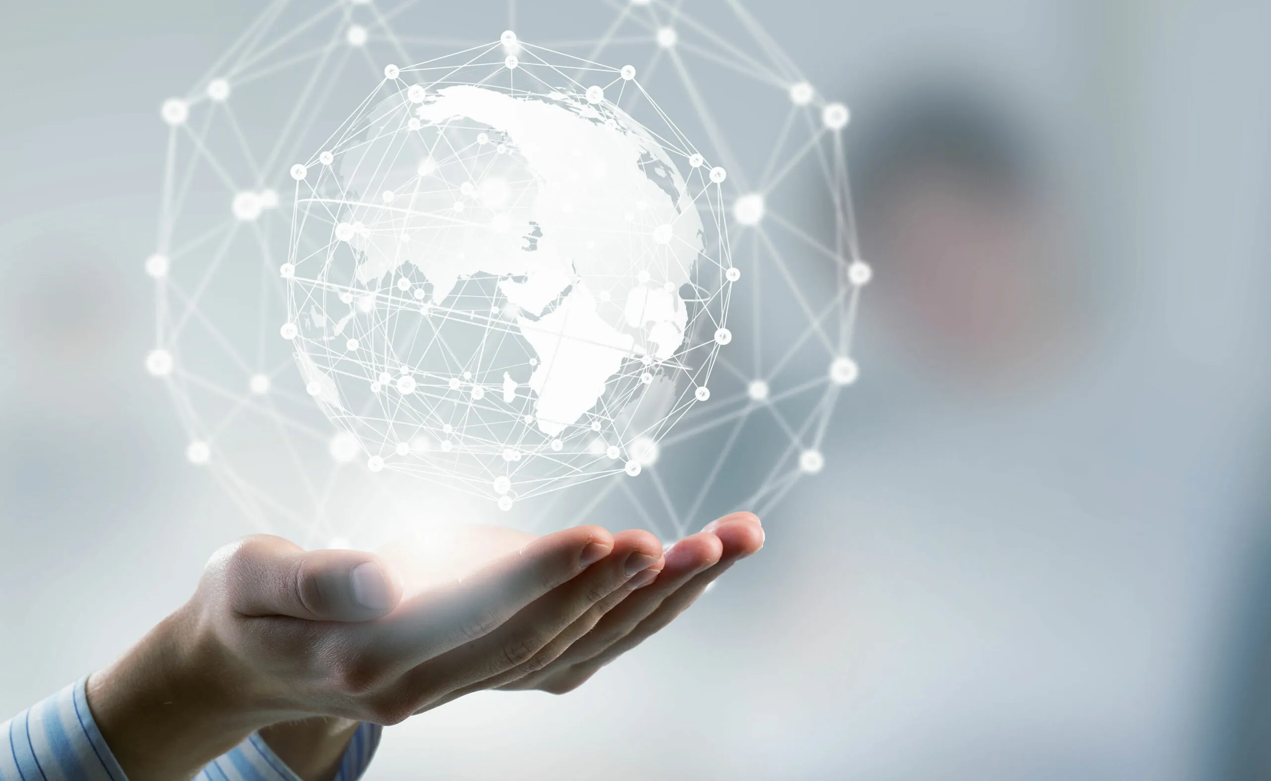 Hand holding a connected digital globe