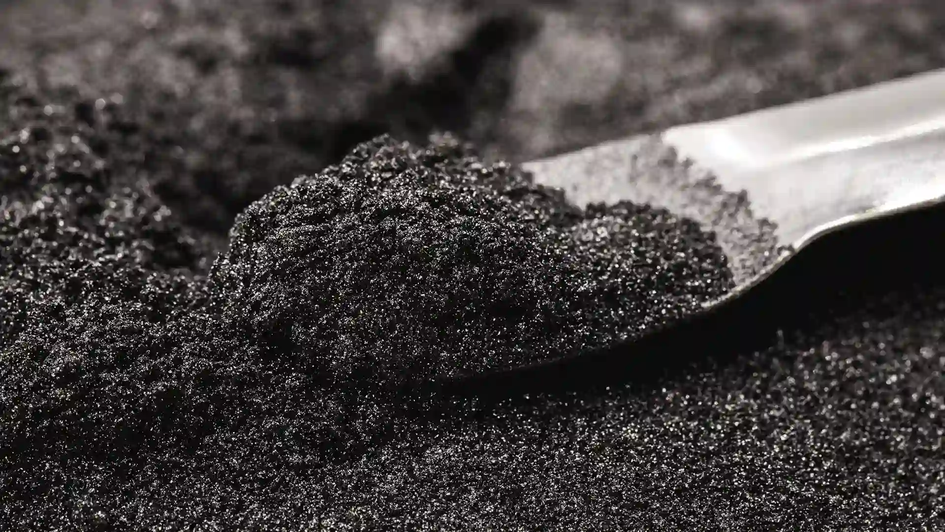 Chrome ore concentrate on a metal scoop