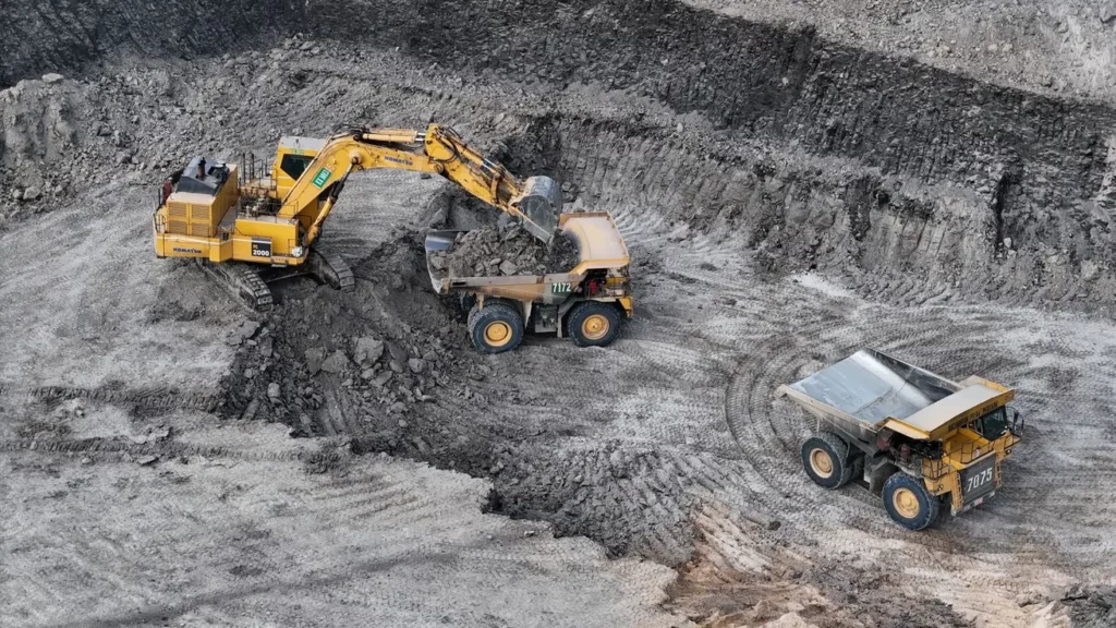 Excavator loading ore into a mining truck